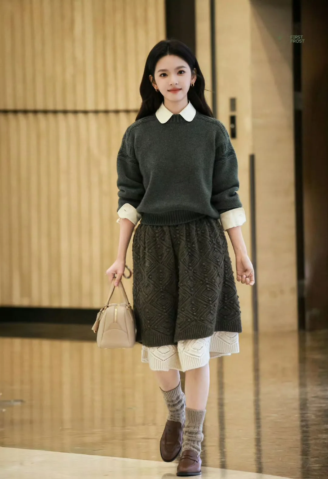 Elegant Fall Layering: Dark Green Sweater, Textured Brown Skirt, and Cozy Accessories