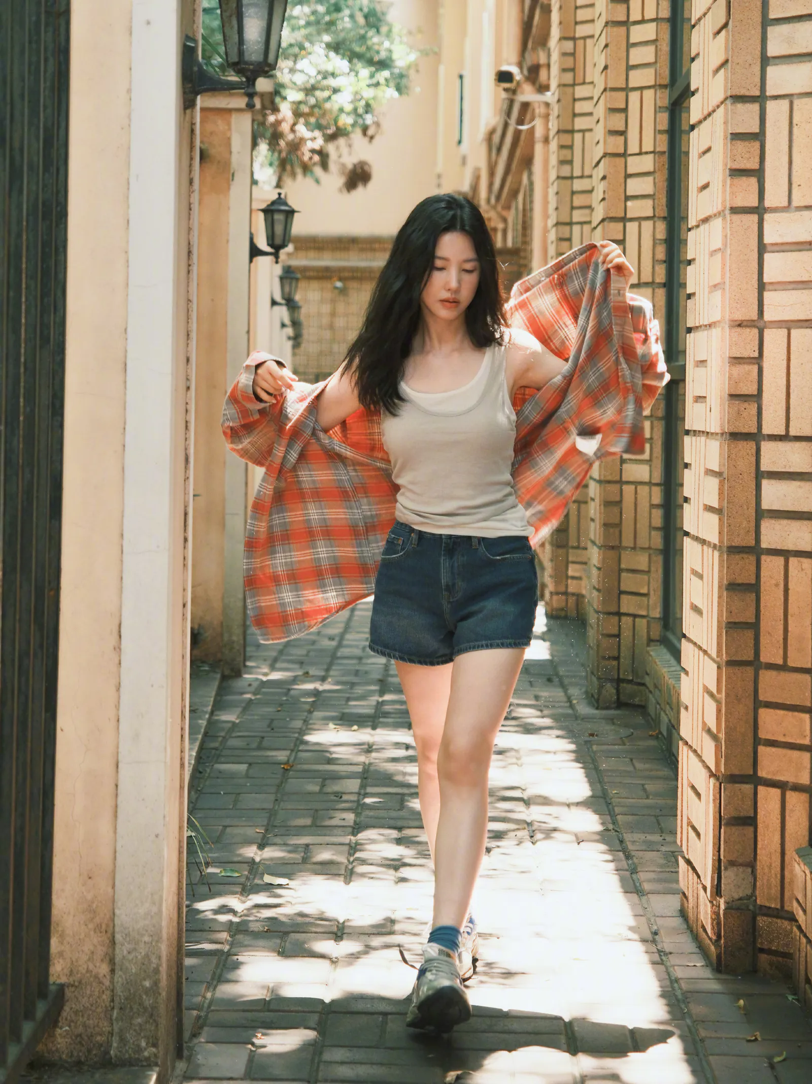 Summer Casual: Plaid Shirt, Neutral Tank Top, and Denim Shorts Ensemble
