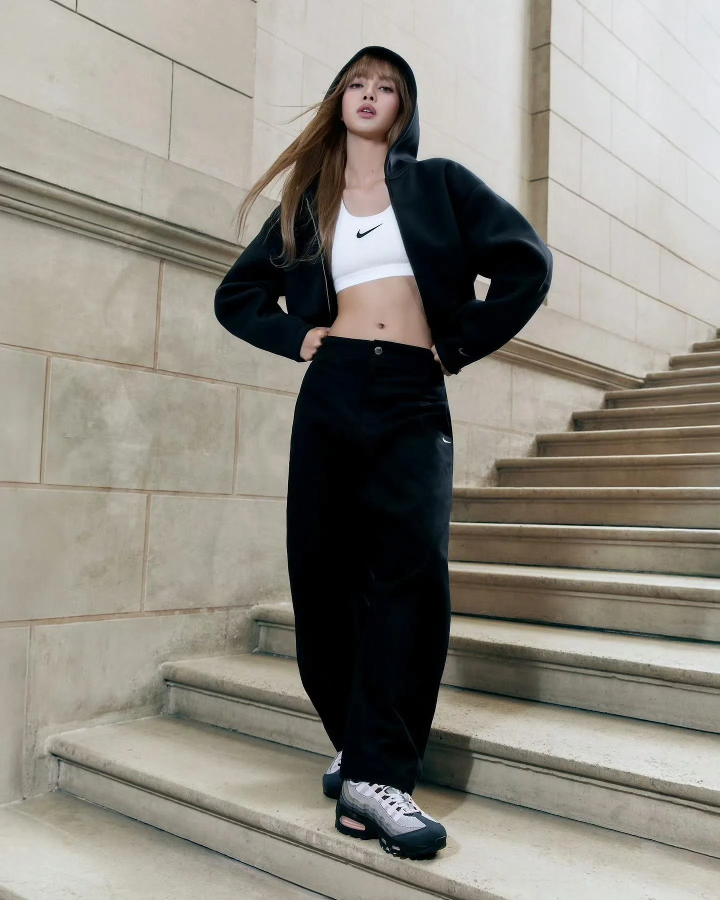 Lisa endorses Nike: Black Hoodie, White Sports Bra, and Relaxed Pants Ensemble