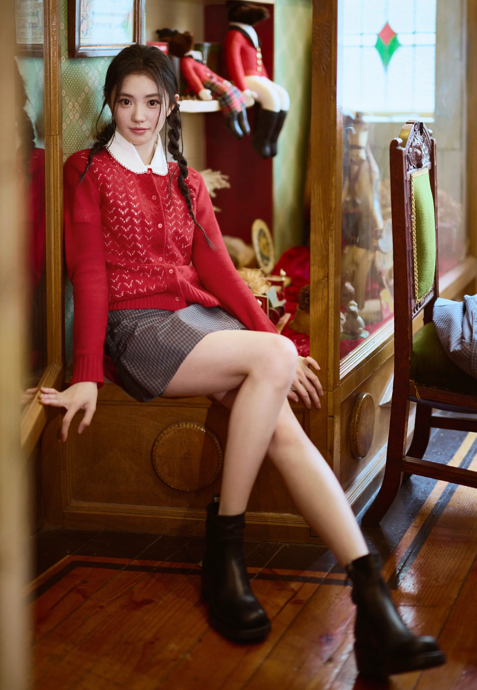 Cozy Contrast: Red Knitted Sweater and Gray Checkered Skirt with Black Ankle Boots