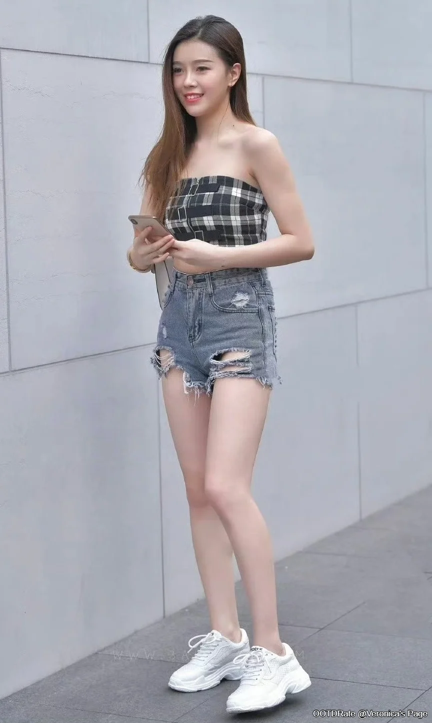 Casual Chic: Plaid Strapless Top and Distressed Denim Shorts with Sneakers