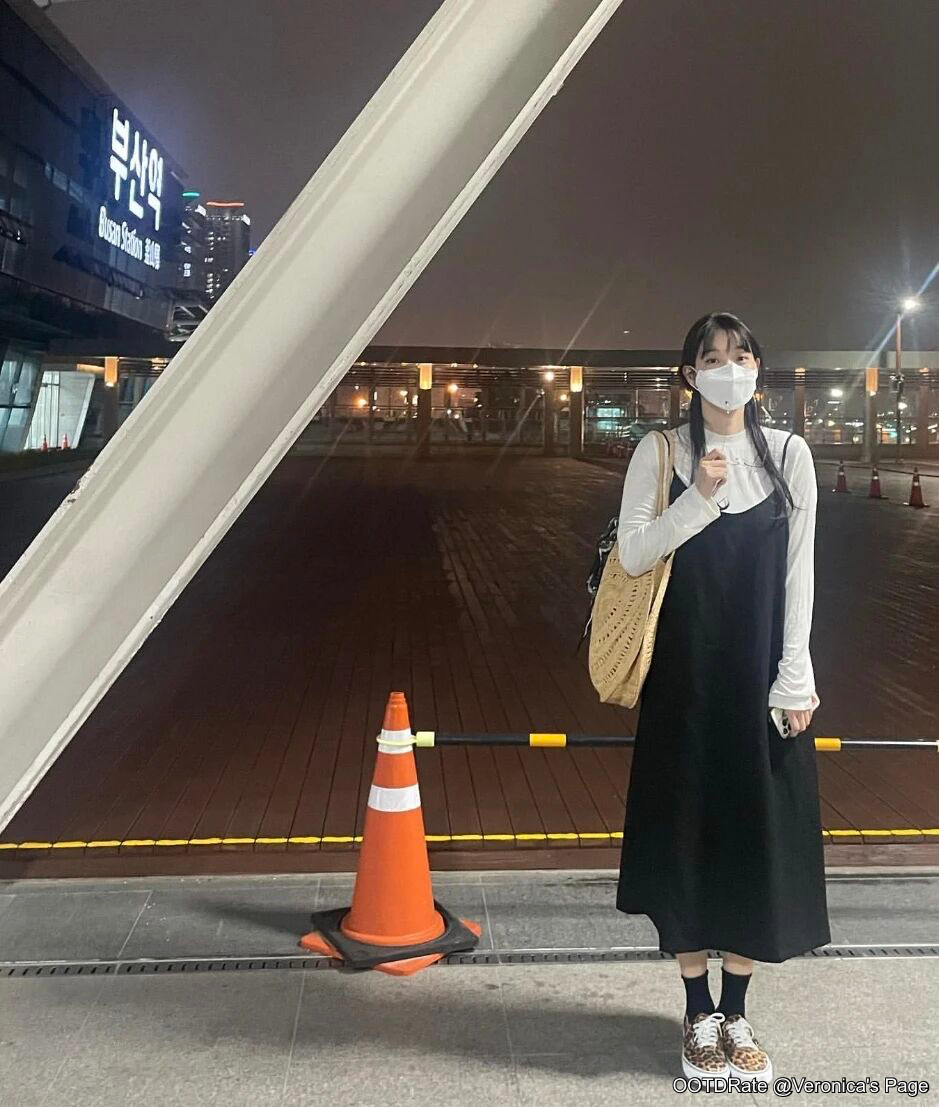 Chic Layering with Black Dress and White Long-Sleeve Top