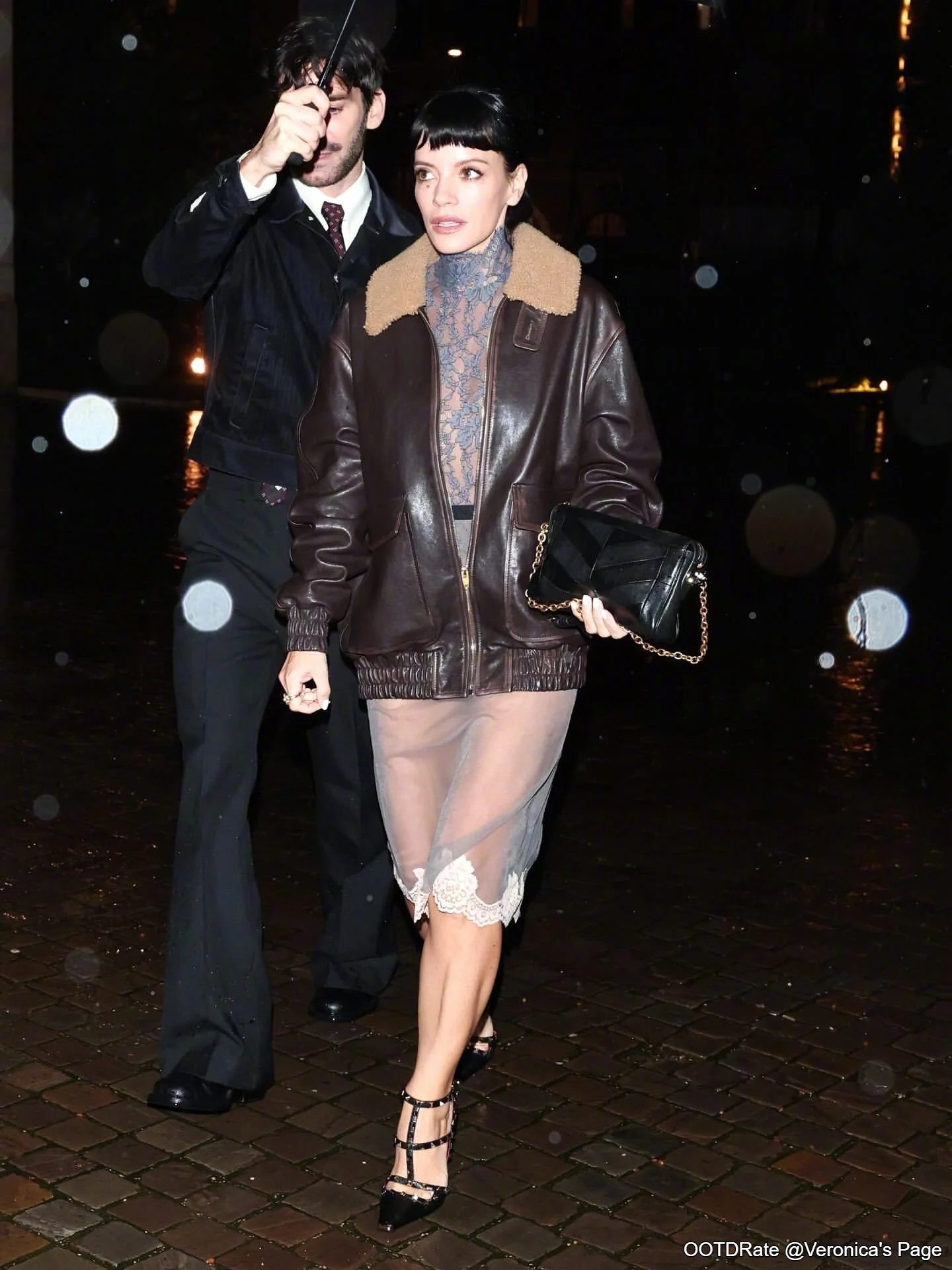 Chic Contrast: Leather Bomber with Sheer Lace Dress and Strappy Heels