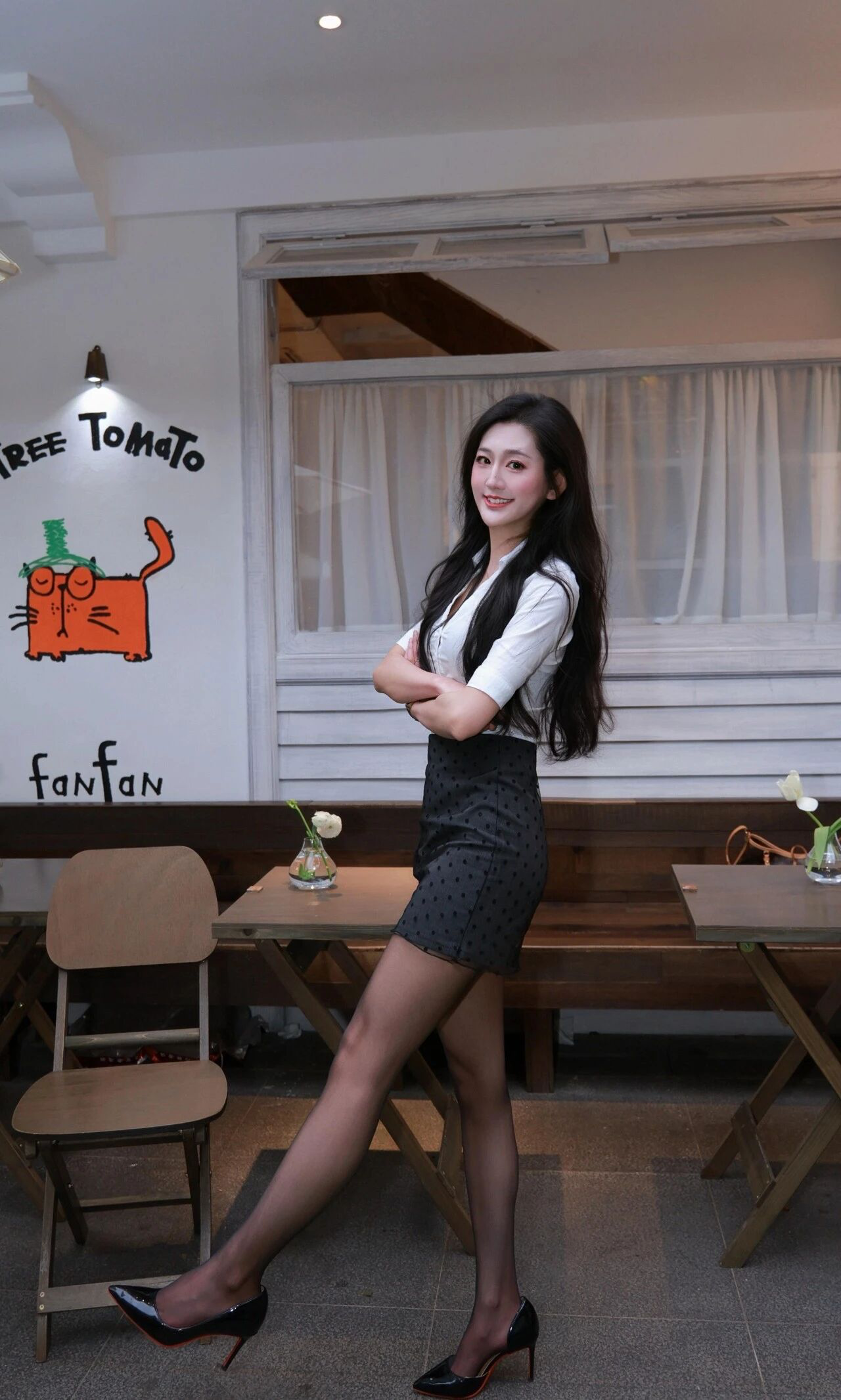 Monochrome Elegance: White Blouse with Dark Patterned Skirt and Heels