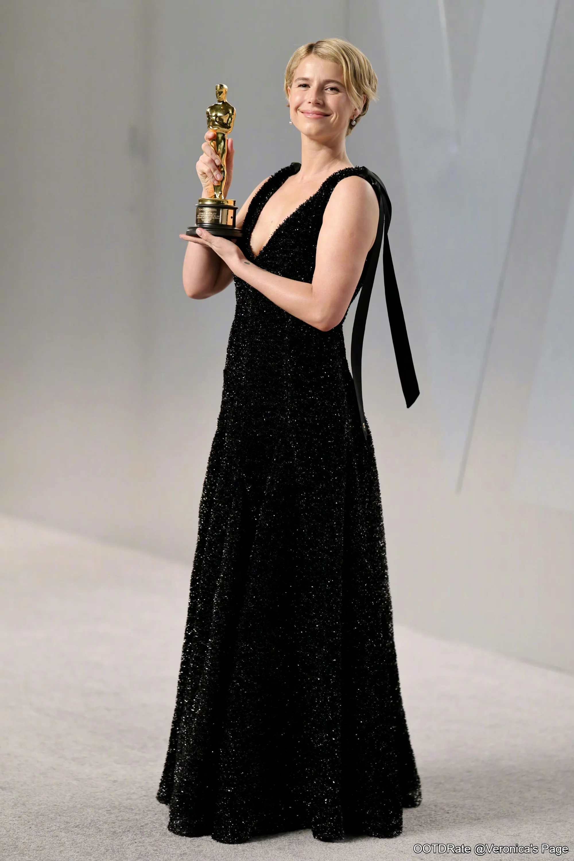 #Jessie Buckley# Elegant Black Evening Gown with Deep V-Neckline and Sparkle Detailing