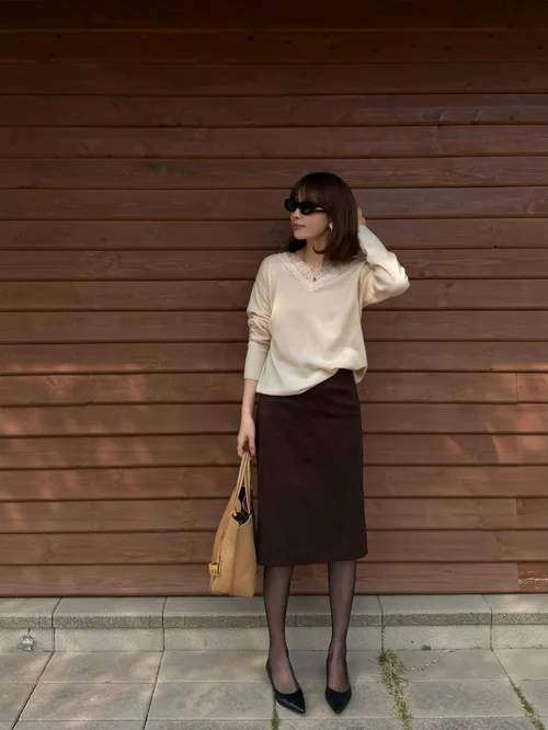 Elegant Cream Top and Brown Pencil Skirt Ensemble with Black Accessories