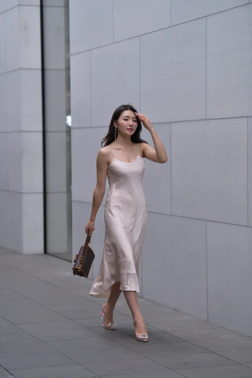 Elegant Silky Slip Dress with Structured Handbag – A Sophisticated Look