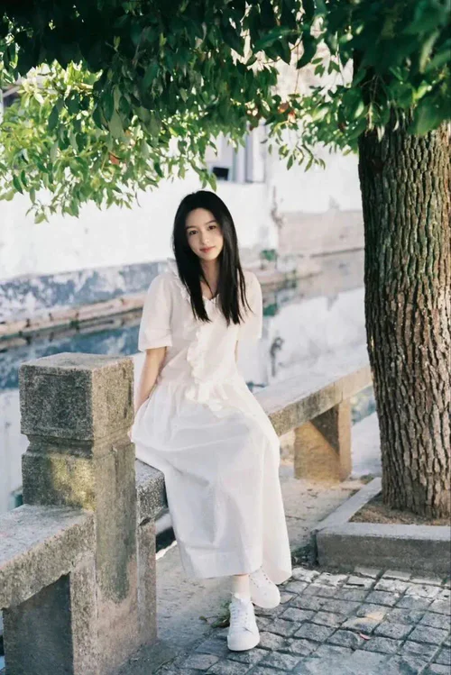 Elegant White Dress with Casual Sneakers for a Chic Summer Look