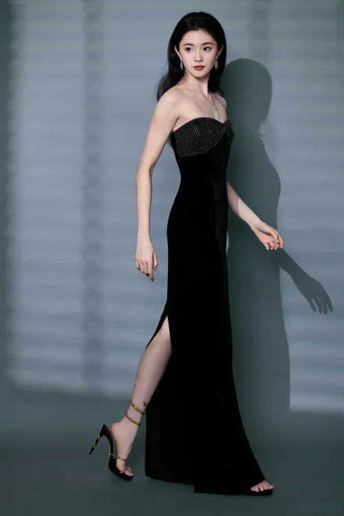 Elegant Black Strapless Evening Gown with Subtle Embellishments and Minimalist Strappy Heels