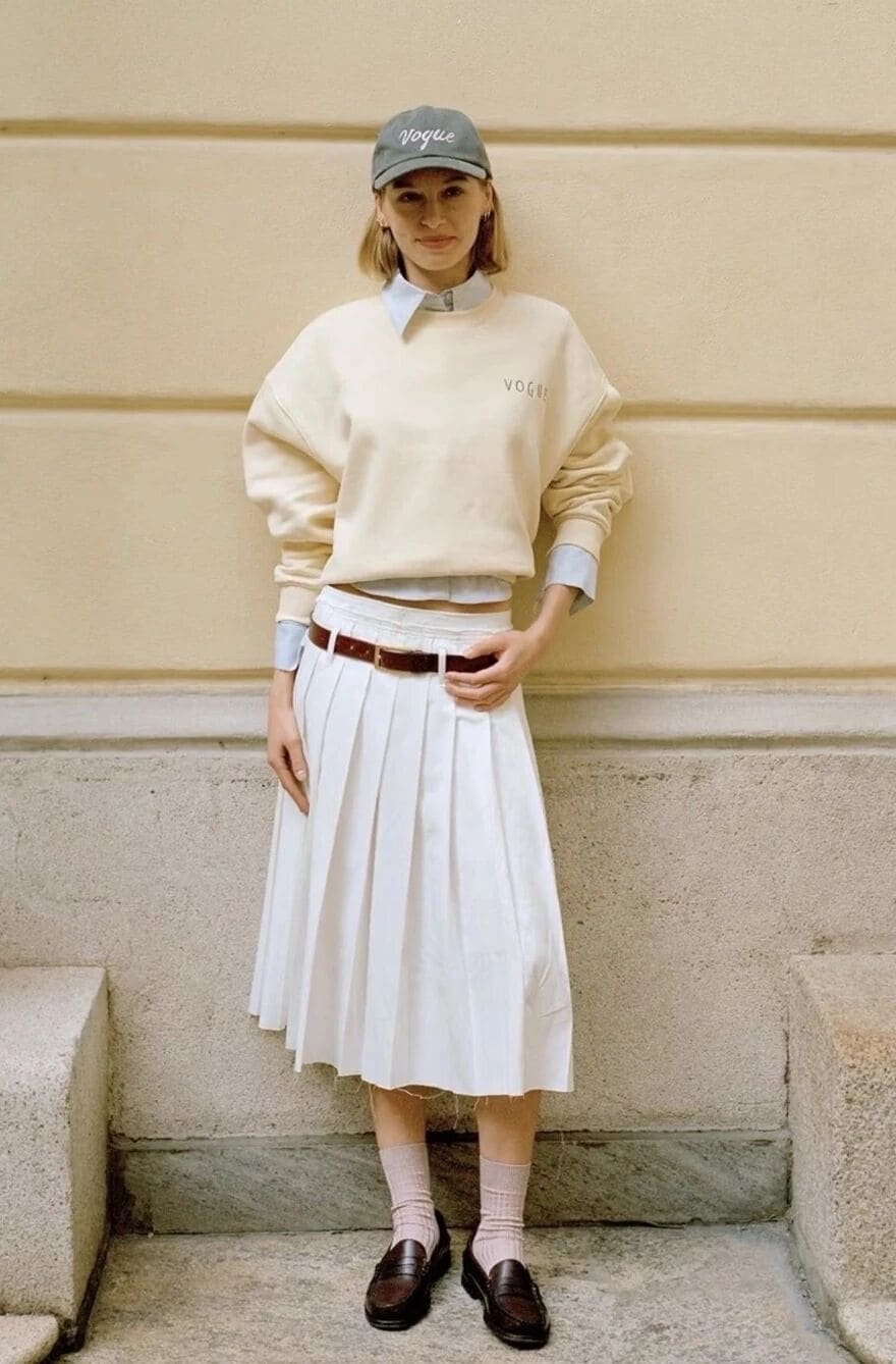 Sweatshirt and shirt layered with pleated skirt for a youthful spring look