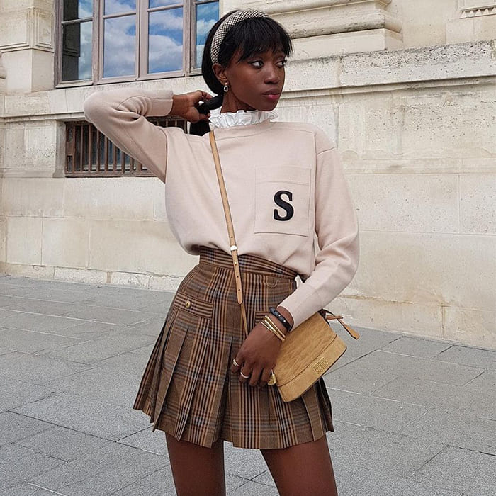 Sweatshirt shirt layering with neutral pleated skirt