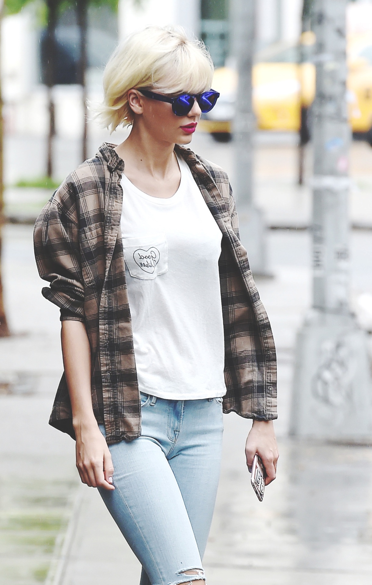 Taylor Swift in white tee plaid shirt and ripped blue jeans