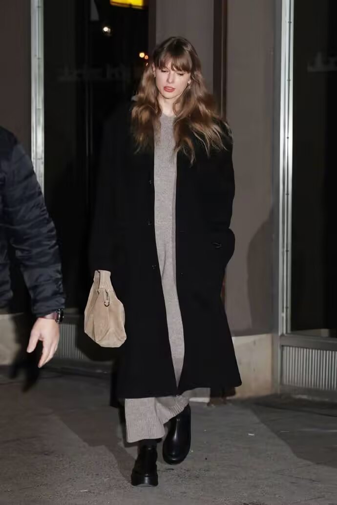 Taylor Swift minimalist winter outfit in gray knits and black coat
