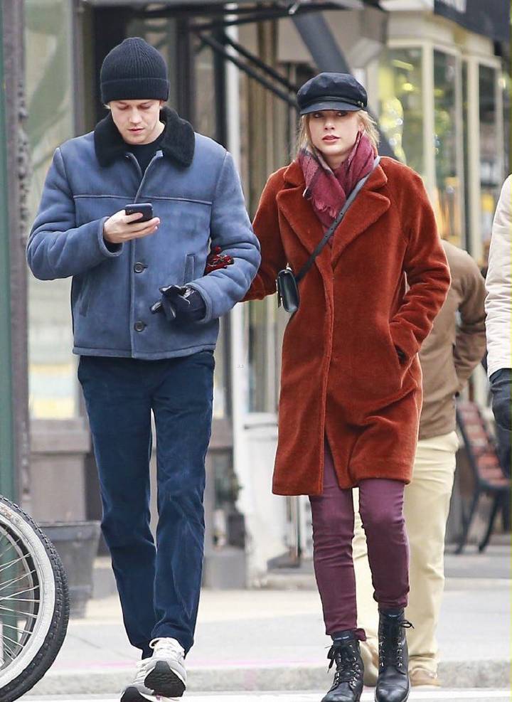 Taylor Swift in teddy bear coat with burgundy pants and winter accessories