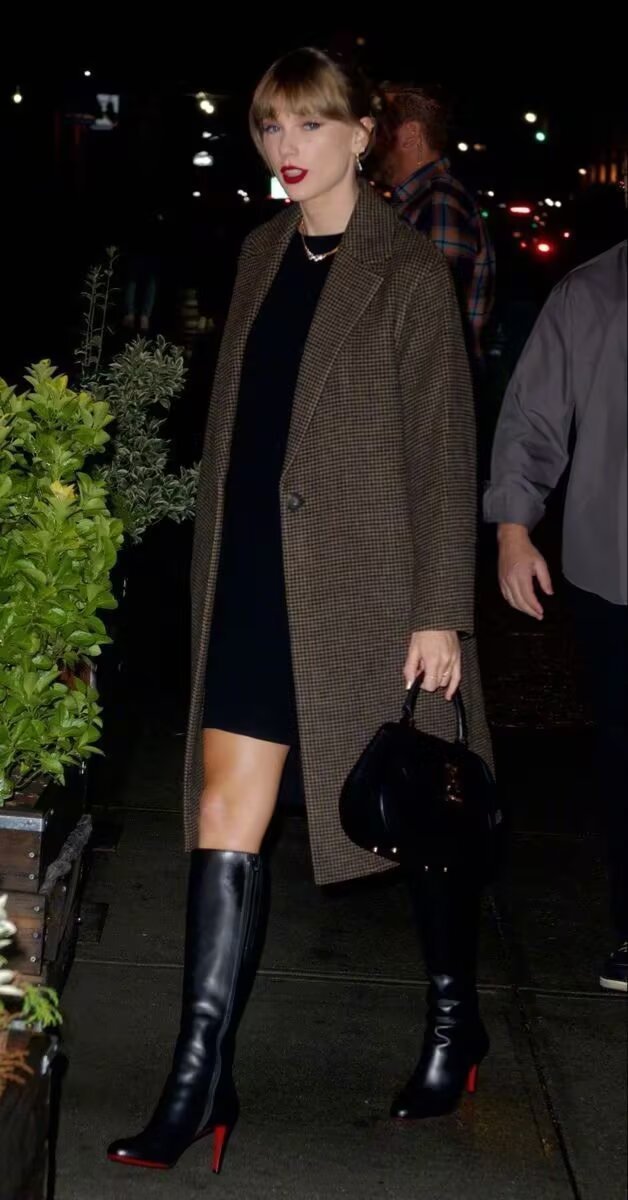 Taylor Swift in tweed plaid coat with black dress and tall boots