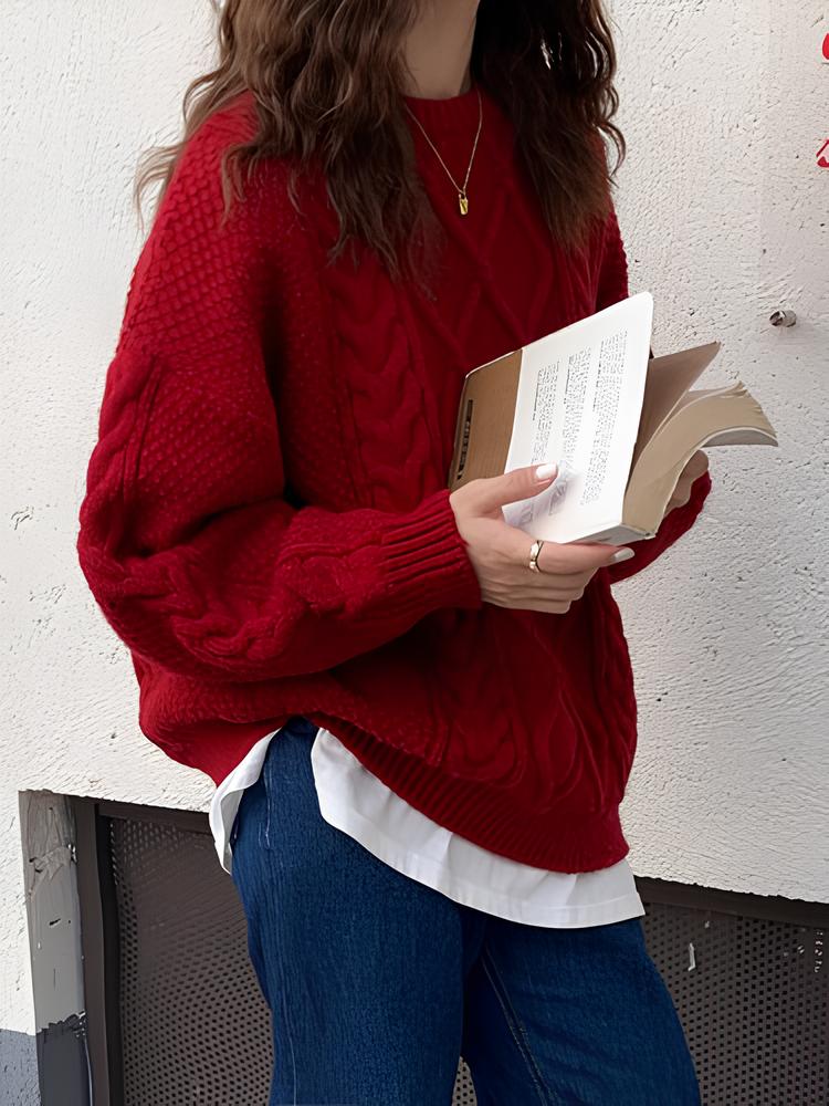 Red cable knit sweater styled with blue jeans